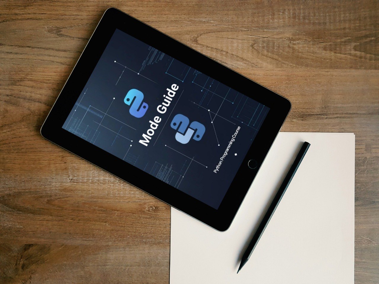 Tablet displaying 'Shift Library' on a wooden surface with a pen and paper.